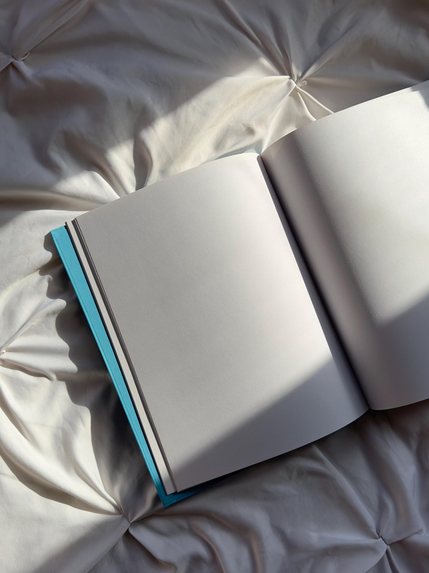 Scrapbook open showing blank white pages.