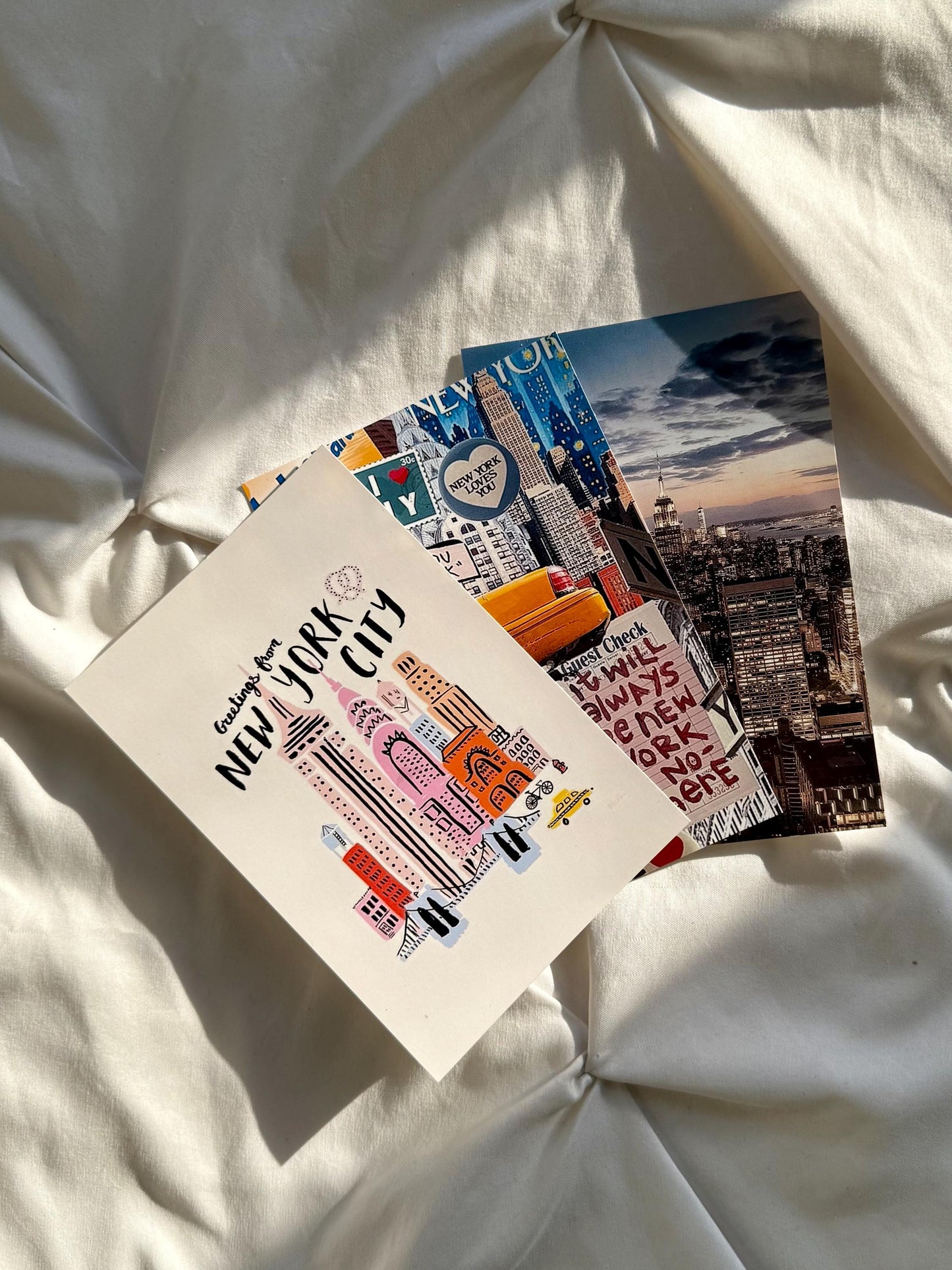 Three glossy art prints with New York City artwork.