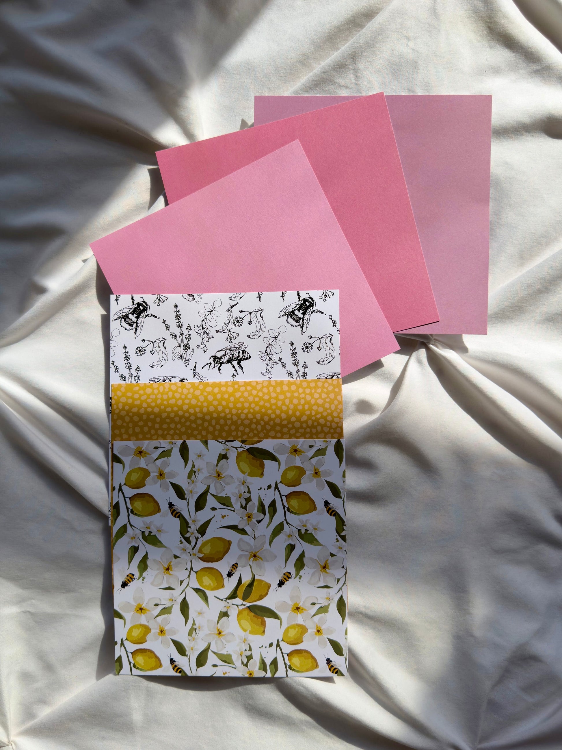 Three pink and three summer design card stock papers.