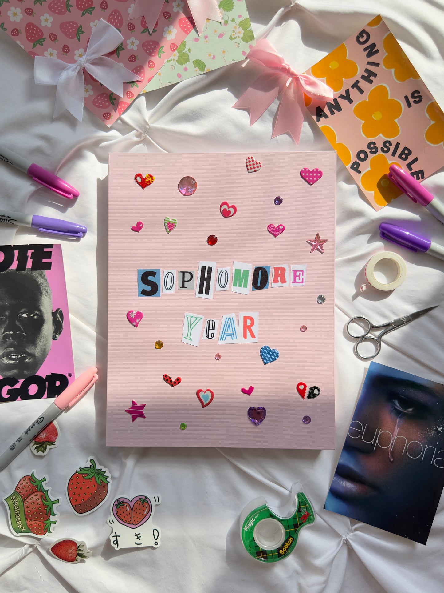 Light pink hardcover scrapbook with “Sophomore Year” written in newspaper letters. Decorated with multicolored heart stickers and jewels.