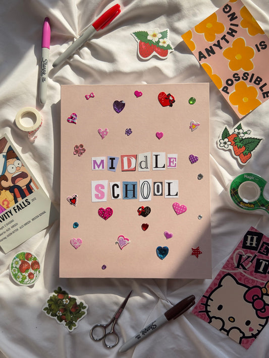 Light pink hardcover scrapbook with “Middle School” written in newspaper letters. Decorated with multicolored heart stickers and jewels.