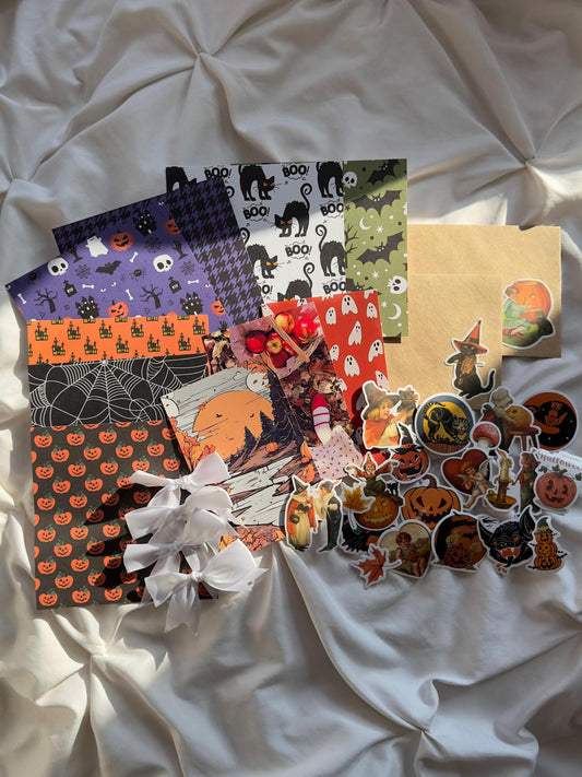 Halloween scrapbook and junk journaling kit with seven spooky scrapbook papers, glossy prints, brown kraft envelope and stickers.