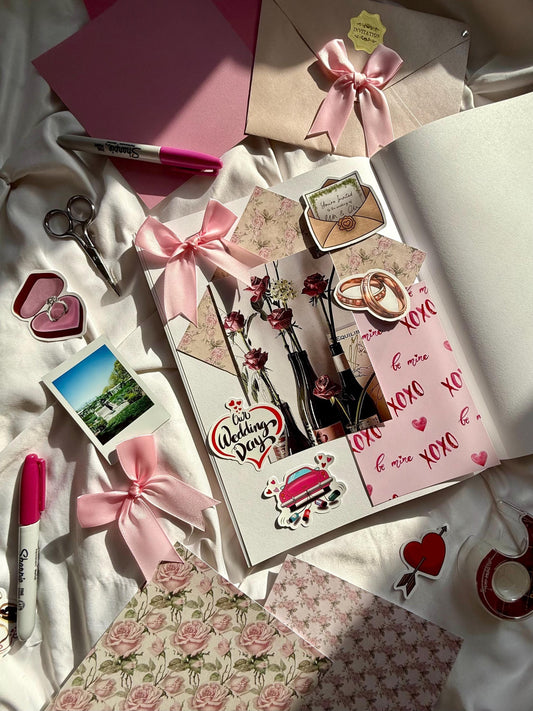 Scrapbook open displaying white page with wedding design including stickers, scrapbook paper and wedding photo.